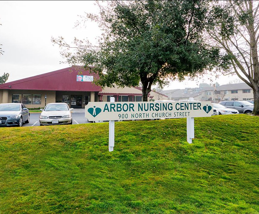 The front of the facility with a sign reading Arbor Nursing Center